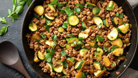 Ground Turkey and Zucchini Skillet - A high-resolution image of a skillet filled with ground turkey and zucchini, topped with fresh herbs.